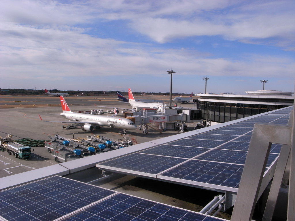 Eco-Friendly Aircraft Over Solar-Powered Airport