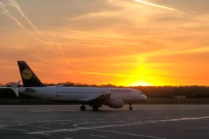 lufthansa-airplane-on-an-airport-runway-at-sunset